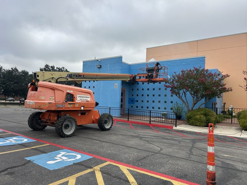 Washing the exterior walls of a commercial building from a boom lift