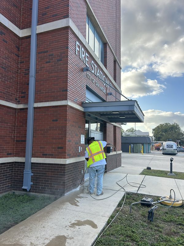Pressure washing the walkway at a City of San Antonio fire station