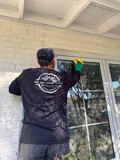 Pure View crew member hand cleaning a home's patio door glass